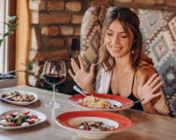Woman eating pasta in an italian restaurant